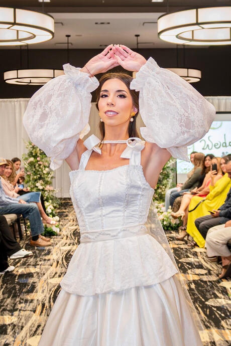 Modern Romance-This bridal look reimagines classic elegance with voluminous, airy sleeves and a sleek, structured bodice. It balances the tradition of a white gown with a fashion-forward silhouette, ensuring the bride feels both sophisticated and unique.