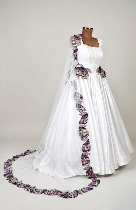 The Royal Narrative-This bridal masterpiece features a signature floor-length drop veil. Adorned with hand-stitched Ankara print motifs. The veil creates a majestic trail that follows your every move.